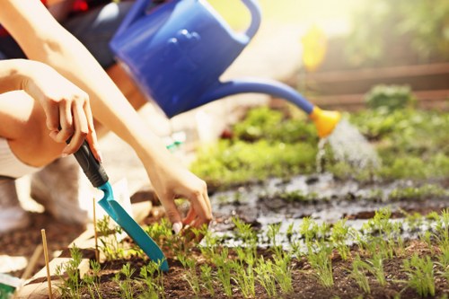 Team of lawn care workers preparing equipment at a local Cricklewood property